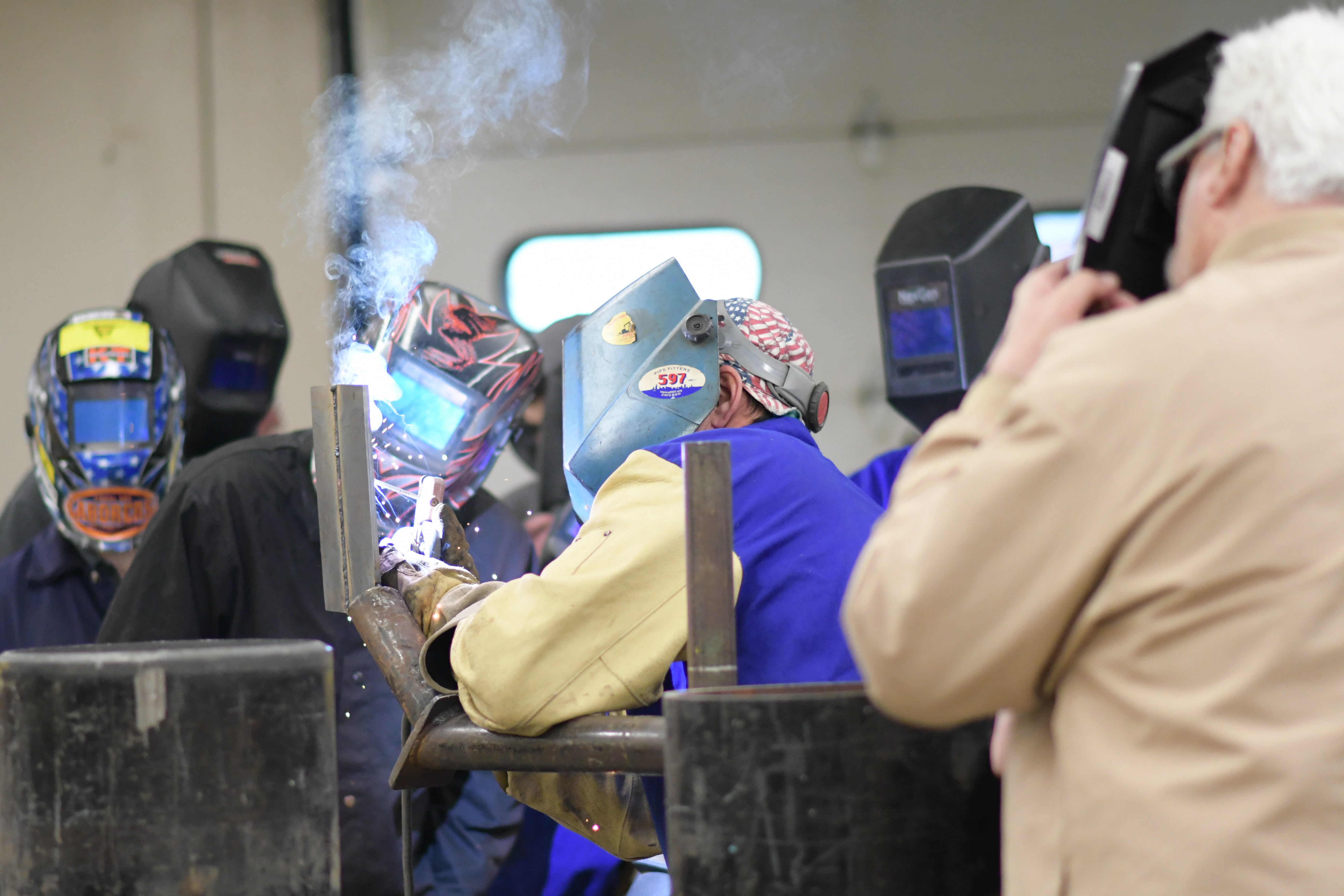 Enbridge master welder Dan Morang demonstrates multi-pass welds to Kish and KEC welding students