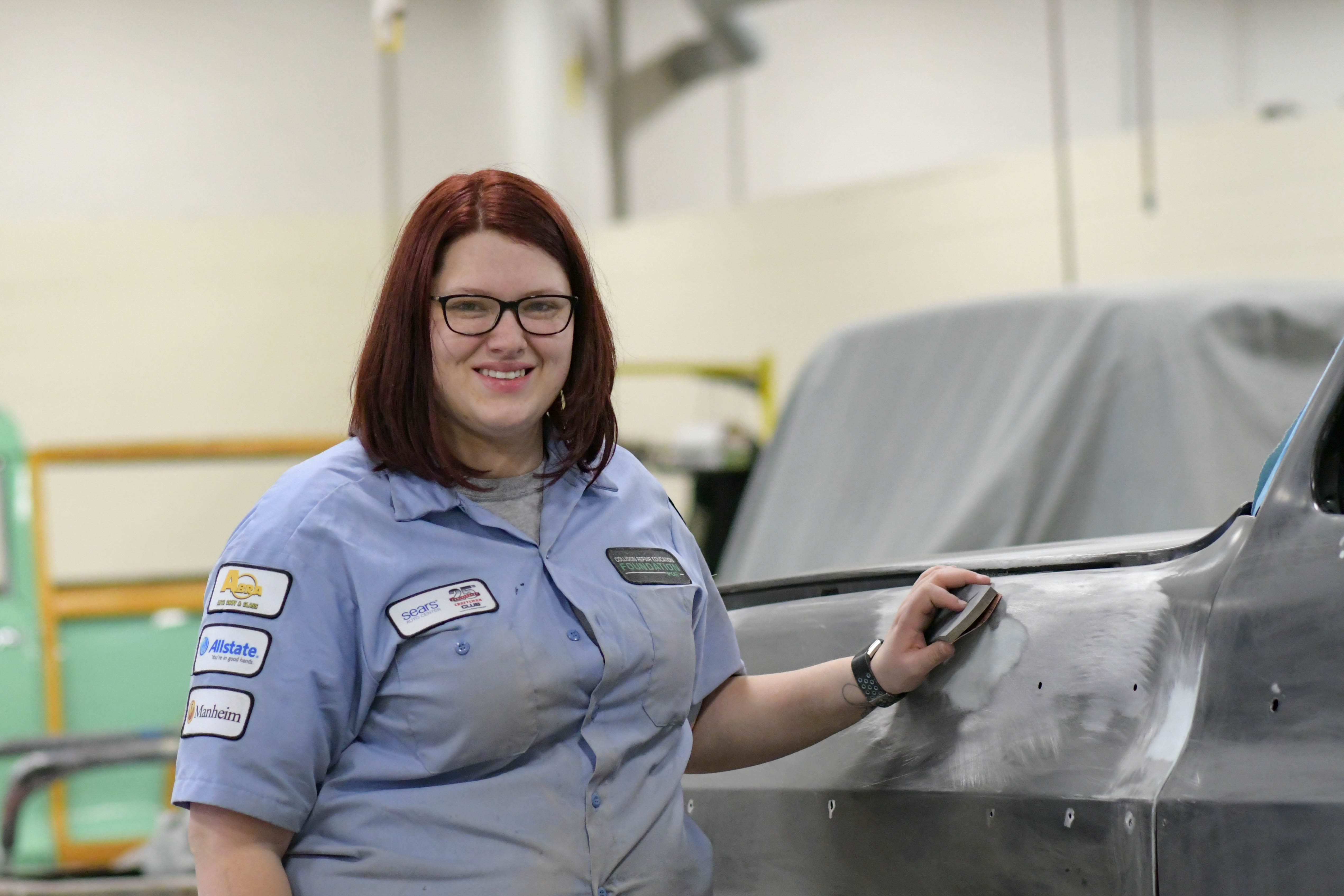 SkillsUSA state competition qualifier Amber Groebner sands a 1980 Chevrolet K5 in her Collision Repair class.